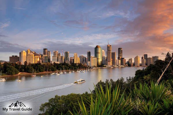 Brisbane’s city skyline with outdoor adventures like kayaking in the foreground.